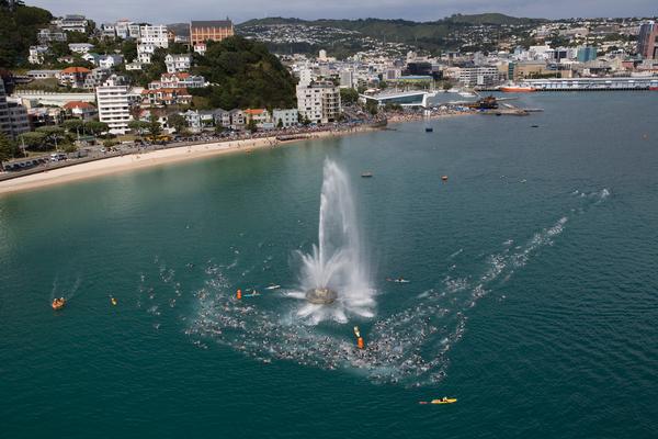 Wide shot of swimmers going around the Oriental Bay fountain in Wellington Harbour during the 2008 race.